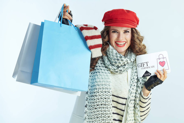 female showing shopping bags with sweaters and discount coupon - Φωτογραφία, εικόνα