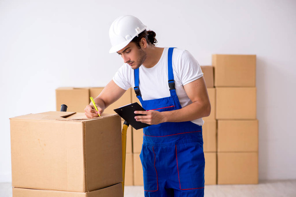 Young male professional mover doing home relocation - Photo, Image