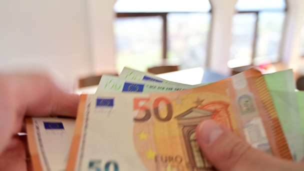 Man counting cash in 50 and 100 euro bank notes - Video
