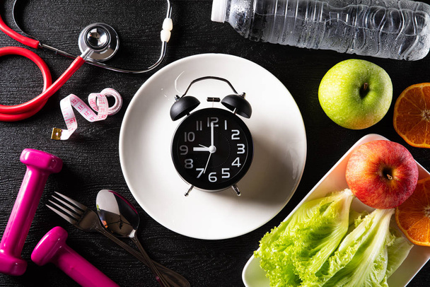 Healthy lifestyle, food and sport concept. Top view of alarm clo - Φωτογραφία, εικόνα