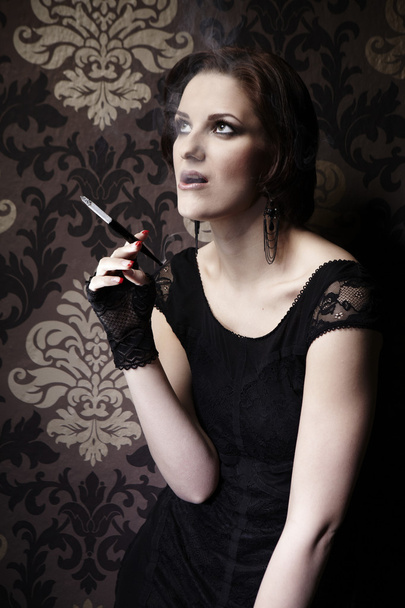 Nice lady model posing as a cigarette smoker - 写真・画像