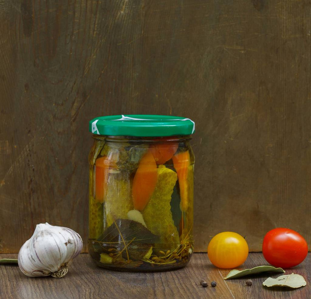 canned vegetables in a jar on a brown background - Foto, afbeelding