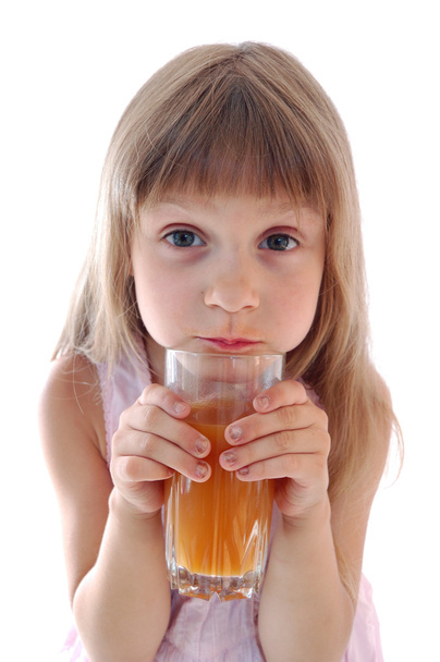 Little girl holds glass of juice. - Foto, Imagem