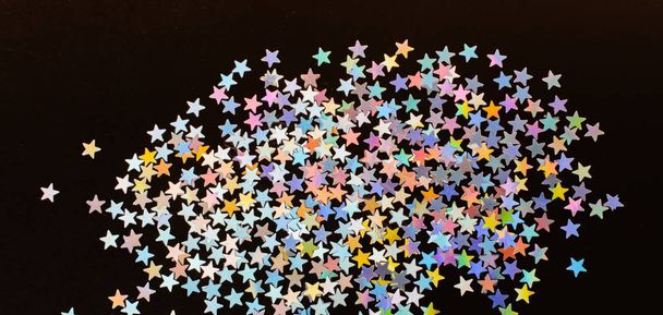 Colorful confetti stars on a dark color background - Photo, Image