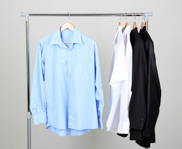 Office male clothes on hangers, on gray background - Foto, imagen