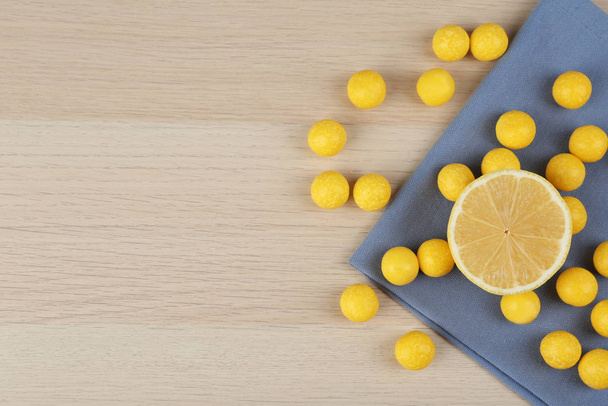 Flat lay composition with tasty lemon drops on wooden table. Spa - Foto, Imagem