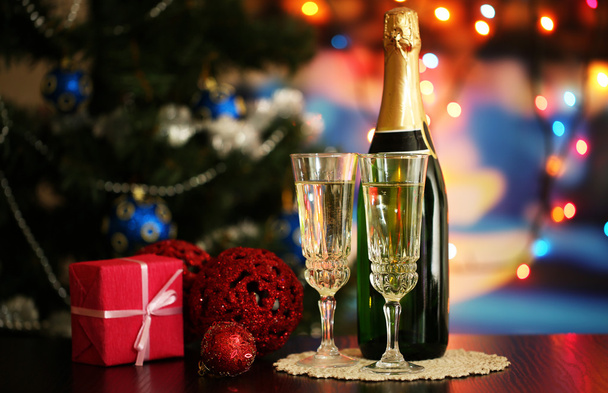 Glasses of champagne and gift on bright background - Photo, image