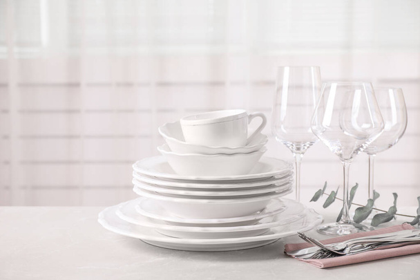Set of clean tableware on light grey marble table - Fotografie, Obrázek