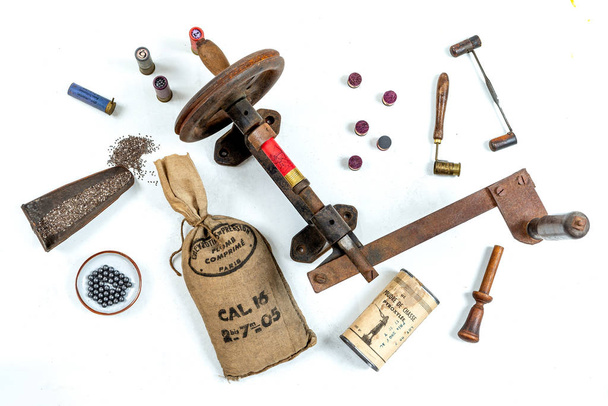 Antique tools for reloading of hunting cartridges, powder measure, cartridge wad tampers, a lot of small bags with lead shots on white background - Fotografie, Obrázek