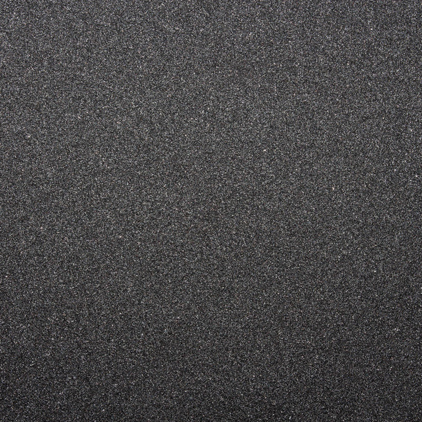 Sandpaper.Texture από μαύρο και τραχύ γυαλόχαρτο. Σκούρο γκρι τραχύ φόντο. - Φωτογραφία, εικόνα