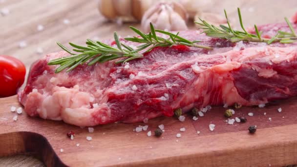 Cooking concept. Raw beef steak on a wooden table. - Footage, Video
