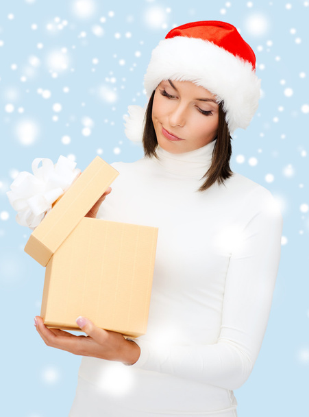 Suspicious woman in santa helper hat with gift box - Foto, afbeelding