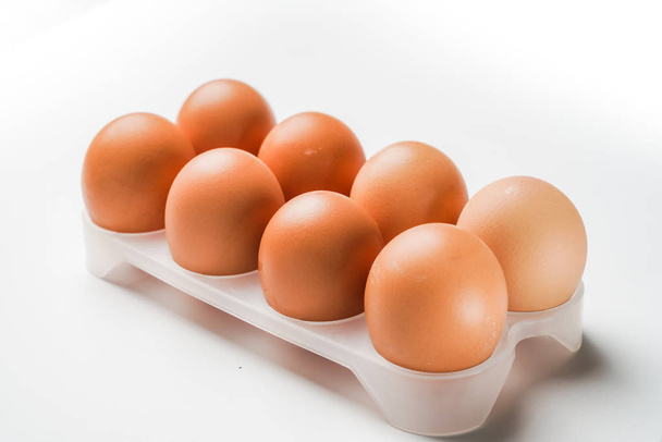 курячі яйця в яєчному лотку на білому фоні
 - Фото, зображення