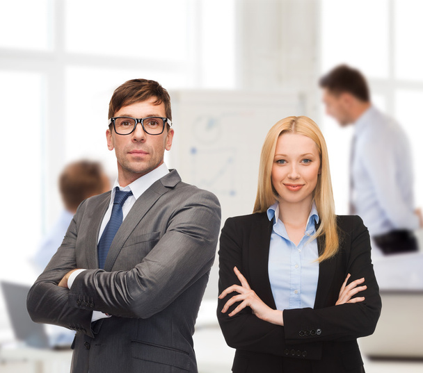 Businessman and businesswoman in the front of team - Foto, imagen
