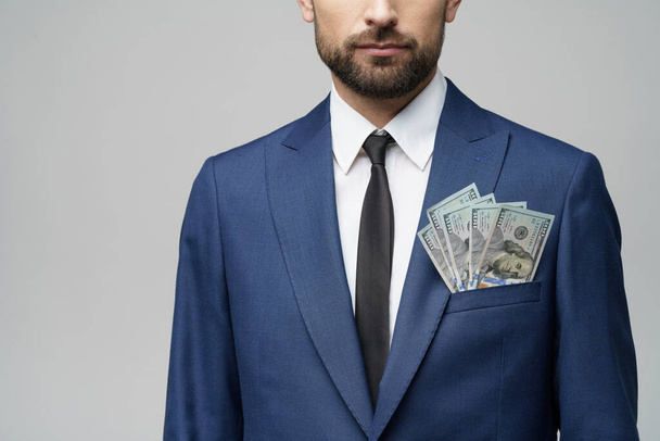 young handsome businessman holding US dollar bills - Fotó, kép