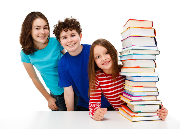 Students peeking behind pile of books - Фото, зображення