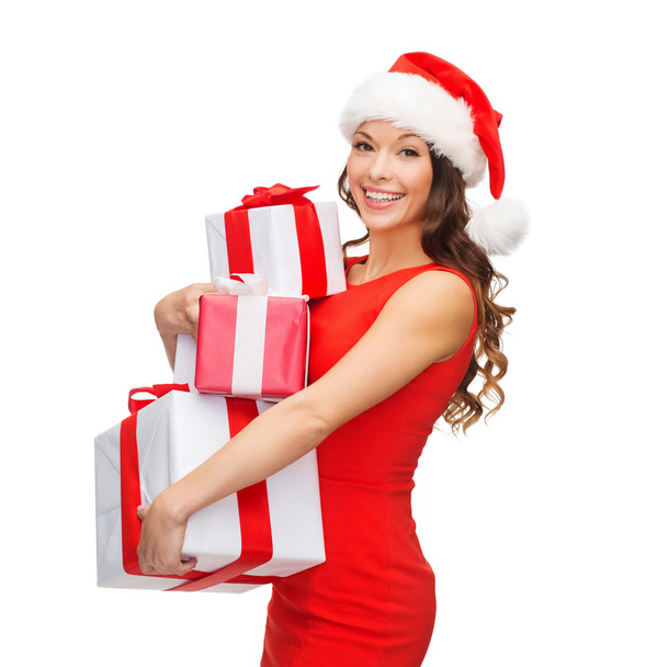Smiling woman in red dress with many gift boxes - Foto, immagini