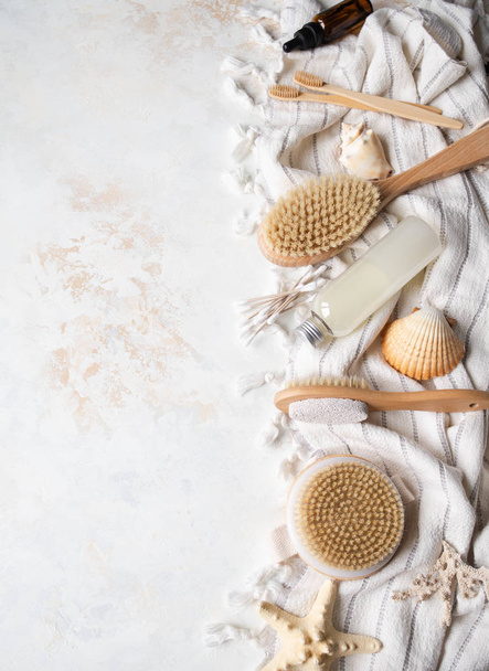 Different body brushes, pumice, cosmetics, bamboo toothbrush, cosmetics on white cotton towel. Copy space. Plastic free life. Zero waste concept. Copy space - Foto, Imagem
