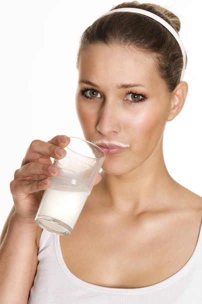 young woman holding glass of milk - Valokuva, kuva