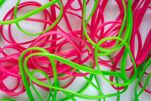 pile of colorful small rubber bands isolated on a white back ground - 写真・画像