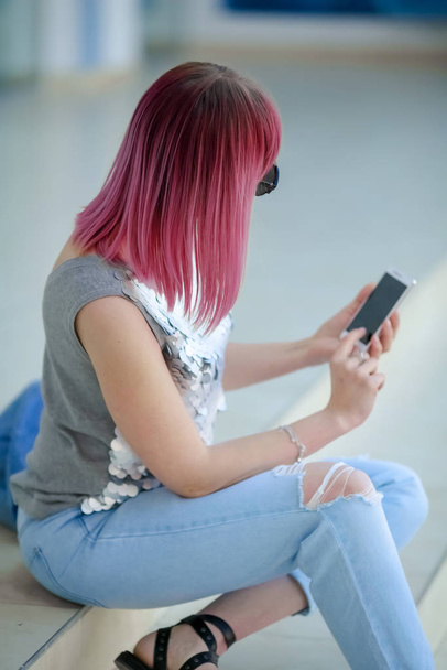 Hipster woman with colored hair uses mobile phone - Foto, immagini