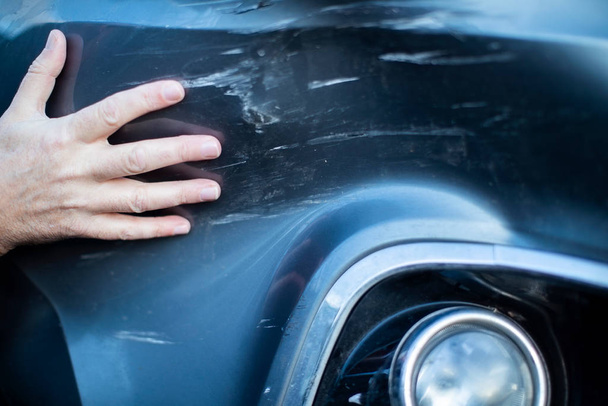 Close up of driver Inspecting Damage To Car After Accident  - Fotografie, Obrázek