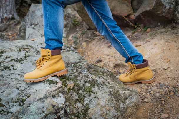 Pair of old yellow working boots on cliff - Fotografie, Obrázek