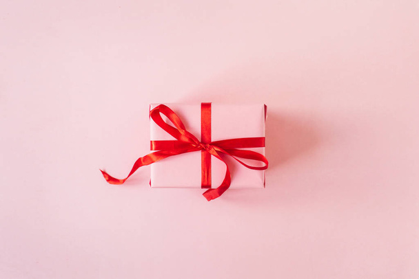 Pink gift box on pink background. Flatlay, top view Valentine's Day holiday concept. - Photo, Image