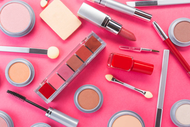 Composition with different makeup products on pink background, top view. beauty products and fashion concept. - 写真・画像