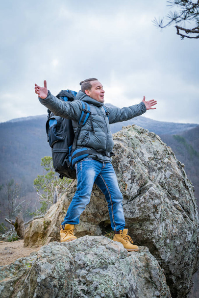 Traveller on the peak of high rocks in autumn. Sport and active life concept - Valokuva, kuva