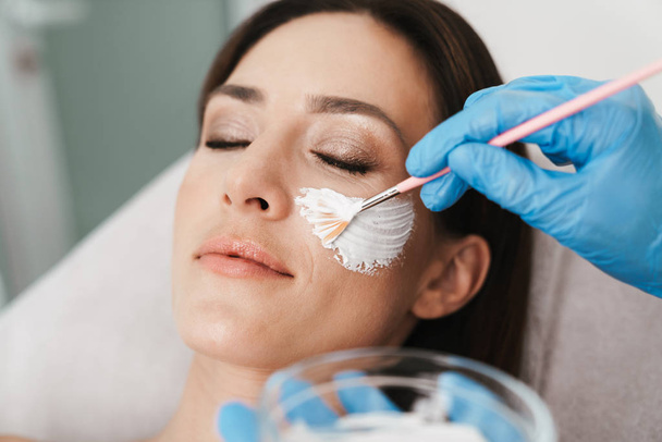 Photo of relaxed caucasian woman getting cosmetic procedure - Foto, immagini
