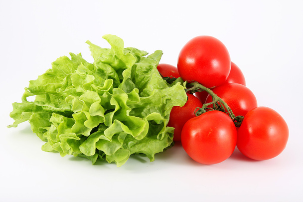 Tomatoes and lettuce on a white background - Photo, Image