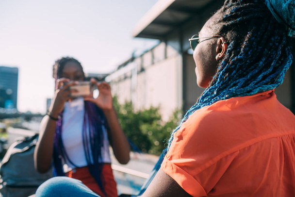 two women sisters outdoor using smart phone taking photos  - Valokuva, kuva