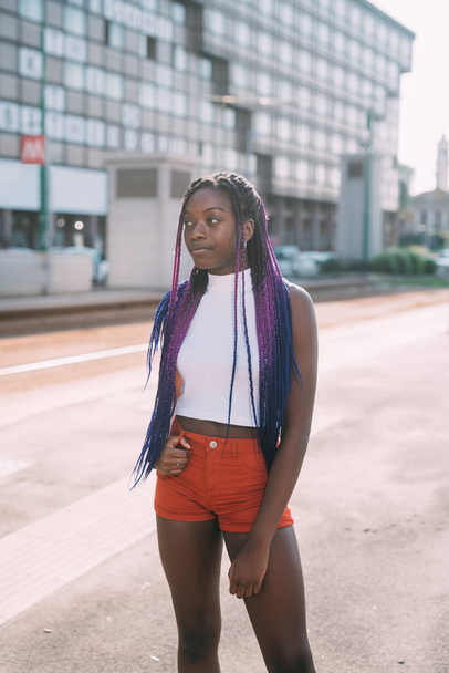 Young beautiful black woman outdoor overlooking pensive - Фото, изображение