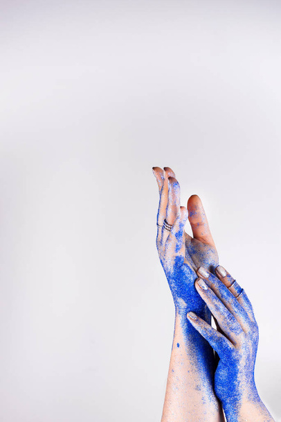 Classic blue glittering palms. Fashion inspired by blue metallic trend. Copy space - Zdjęcie, obraz