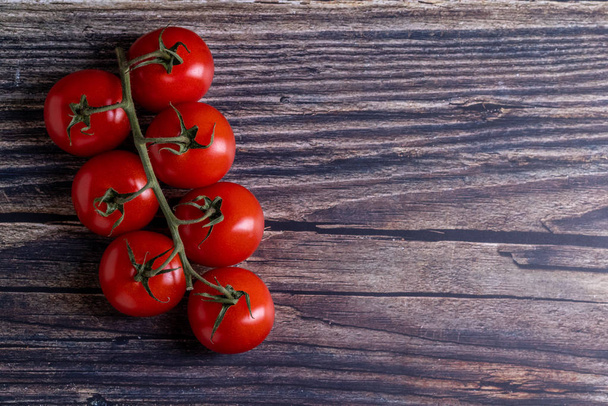 Cherry tomatoes on a wooden table - Photo, Image