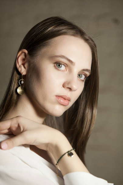 Portrait of beautiful fair young woman with jewelry, one light source - 写真・画像