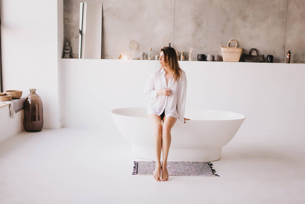 Beautiful sexy lady in elegant white shirt in a bathroom. - Foto, Imagem
