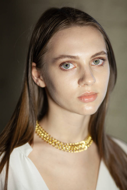 Portrait of beautiful fair young woman with jewelry, one light source - Фото, зображення