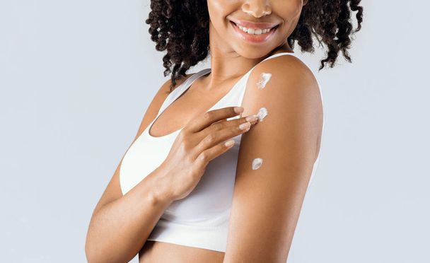 Young woman using cream for smooth skin - Photo, Image