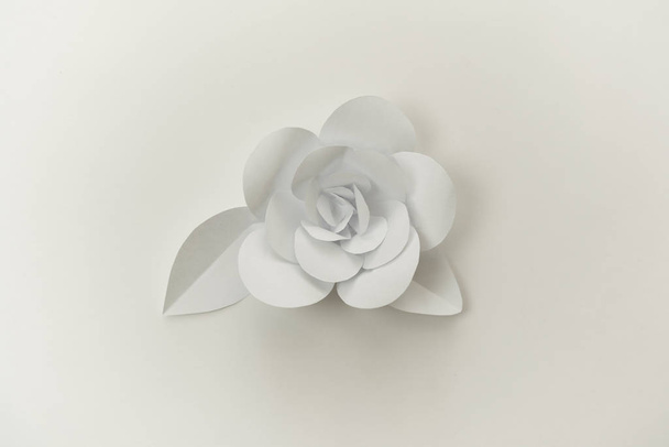 Closeup hand crafted paper flower with leaves. - Photo, image