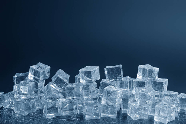 Crystal clear ice cubes with water drops against black background - Fotó, kép