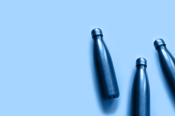 Butelki z wodą zerową wielokrotnego użytku w kompozycji otwartej z odcieniem niebieskiego koloru - Zdjęcie, obraz