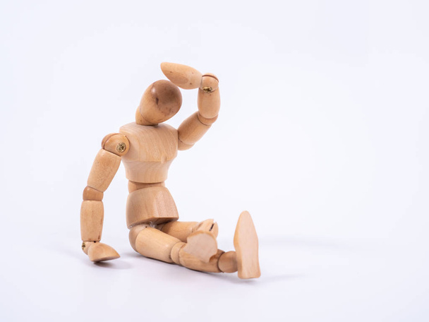 The wooden dummy sits on white background - 写真・画像