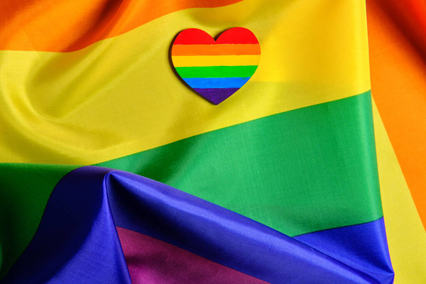 Close-up view of the LGBT pride flag with the heart coloured in LGBTQ pride colours. Concept of the Valentine day, freedom, equality - Photo, Image