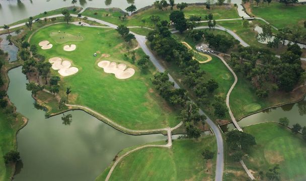 Golf course and lake. Aerial view. - 写真・画像