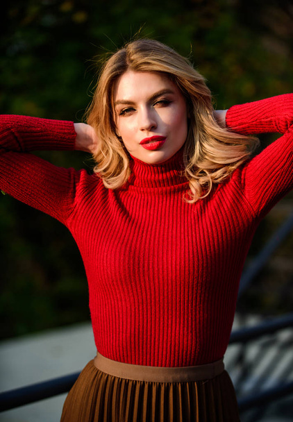 Happy to be around. cosmetics and skin care trend. autumn woman curly hair. female beauty. haidresser and makeup. fall fashion season. girl long blond hair. girl red lipstick in knitwear sweater - Фото, зображення