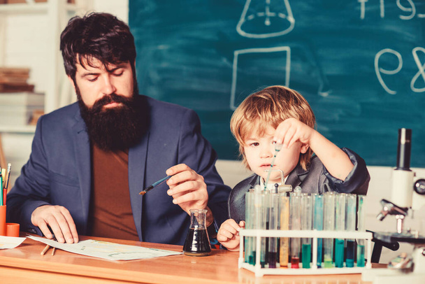 teacher man with little boy. school lab equipment. father and son at school. using microscope in lab. Back to school. student doing science experiments with microscope in lab. The roots of education. - Foto, Imagem