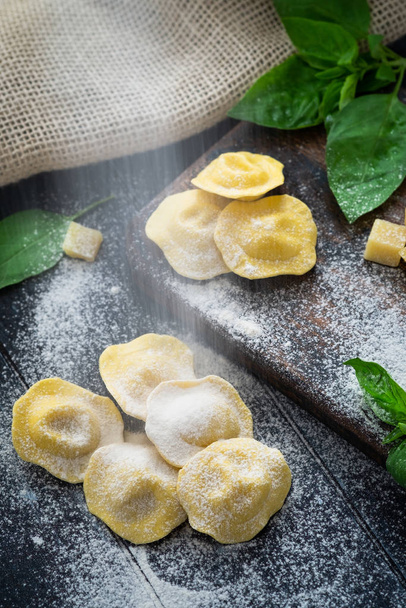 Ravioli pasta espolvoreada con harina en la mesa de madera de la cocina
,  - Foto, Imagen