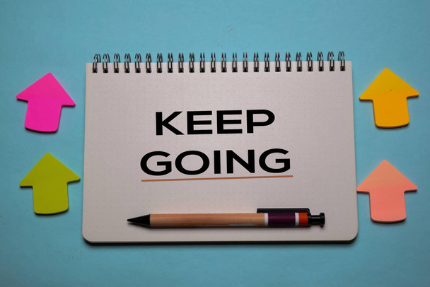 Keep Going write on a book isolated on office desk. Christian faith concept - Photo, image